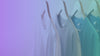 Video of shirts hanging and they start from brown and then go to different shades of blue. almost the color of the rainbow. 